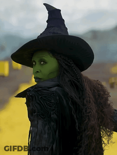 Woman In Witch Costume Green Face Paint Black Hat GIF