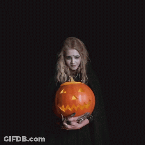 Woman In Witch Costume Holding Pumpkin Saying I Wish You A Happy Halloween GIF