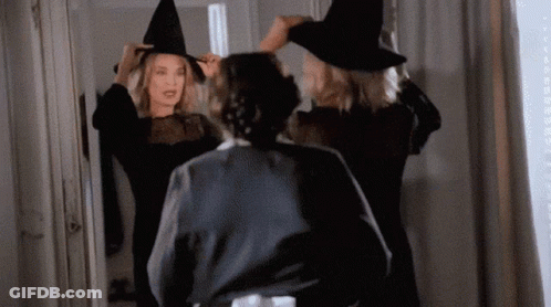 Woman In Witch Costume Looking In Mirror GIF
