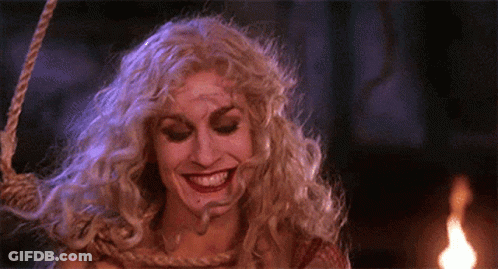 Woman In Witch Costume Smiling Hanging On Rope GIF