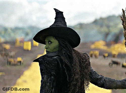 Woman In Witch Costume Standing In Field GIF