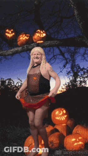 Woman In Witch Costume With Pumpkins GIF