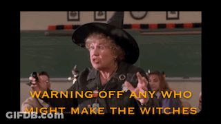 Woman In Witch Hat Warning Off Witches GIF