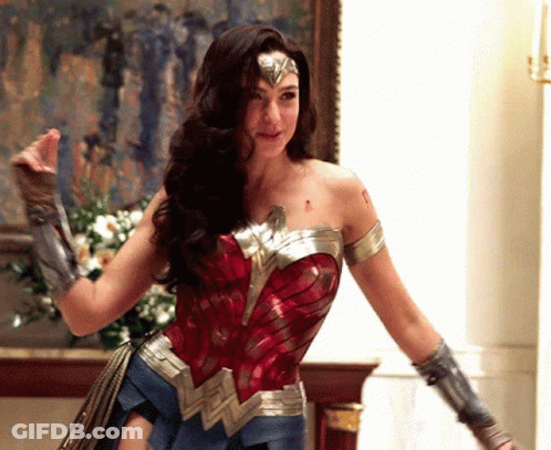 Woman In Wonder Woman Costume In Front Of Painting GIF