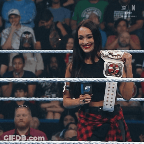 Woman In Wrestling Ring Holding Belt With B GIF