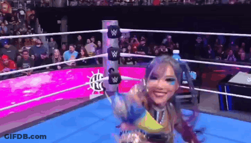 Woman In Wrestling Ring Holding Water Bottle GIF