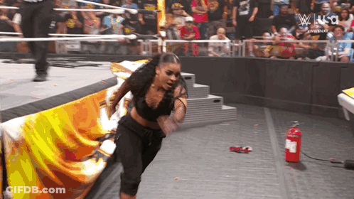 Woman In Wrestling Ring With Fire Extinguisher GIF