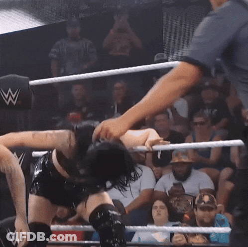 Woman In Wrestling Ring With Referee And Crowd GIF