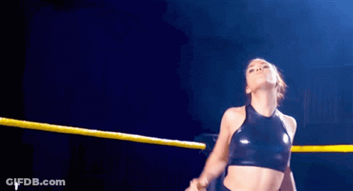 Woman In Wrestling Ring With Yellow Rope Around Waist GIF