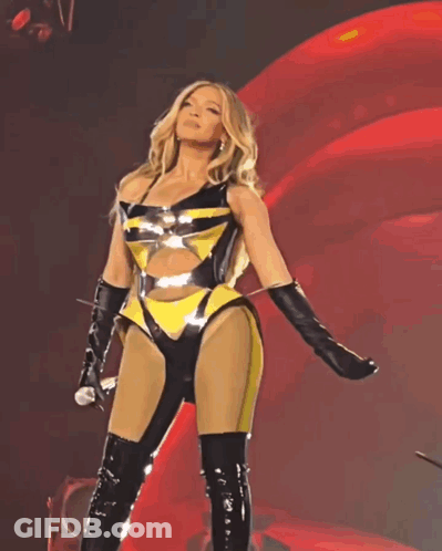 Woman In Yellow And Black Holding Microphone GIF