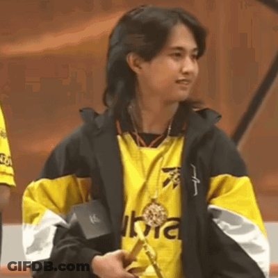 Woman In Yellow And Black Jacket Holding Medal GIF