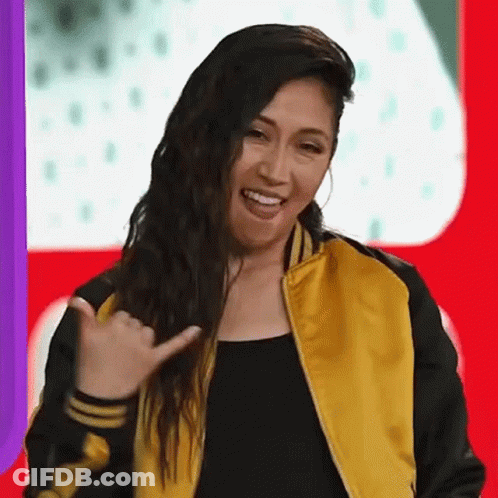 Woman In Yellow And Black Jacket Smiling Funny Face GIF