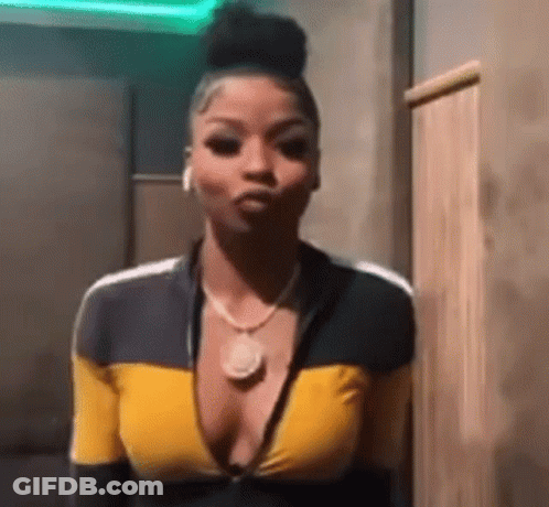 Woman In Yellow And Black Top Making Face GIF