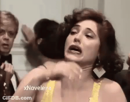 Woman In Yellow Bra Making Funny Face With Man In Tuxedo GIF