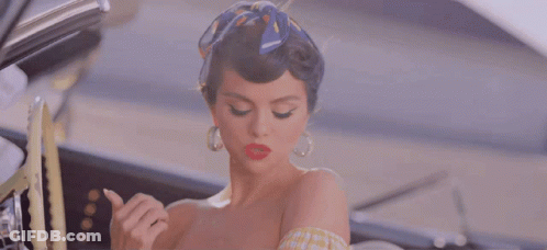 Woman In Yellow Checkered Top Sitting In Car GIF