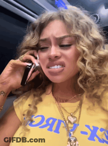 Woman In Yellow CK T-Shirt Talking On Phone GIF