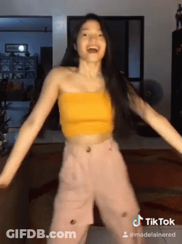 Woman In Yellow Crop Top And Pink Pants Dancing GIF