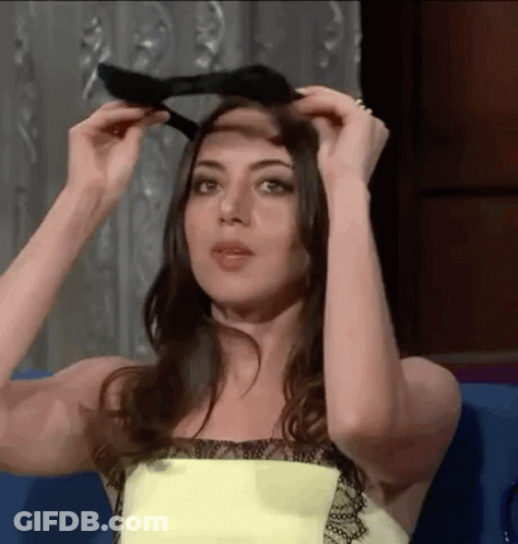 Woman In Yellow Dress Adjusting Hair GIF