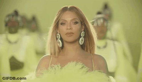Woman In Yellow Dress And Gloves Singing Into Microphone GIF