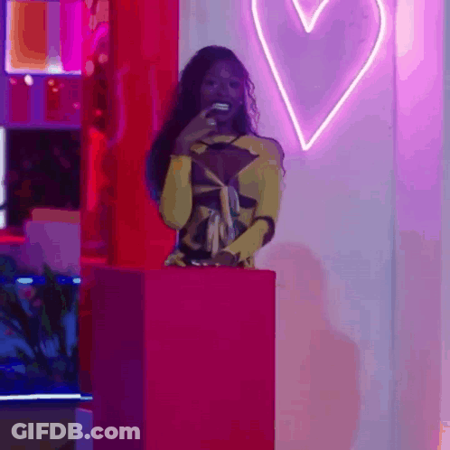 Woman In Yellow Dress And Pink Box With Heart GIF