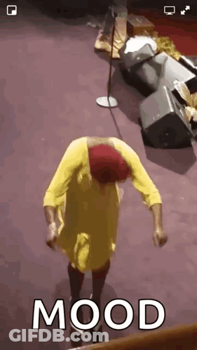Woman In Yellow Dress Dancing At Microphone With Mood GIF