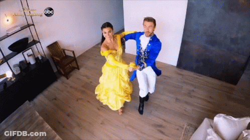 Woman In Yellow Dress Dancing With Man In Blue Costume On ABC GIF