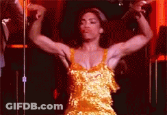 Woman In Yellow Dress Flexing Muscles GIF