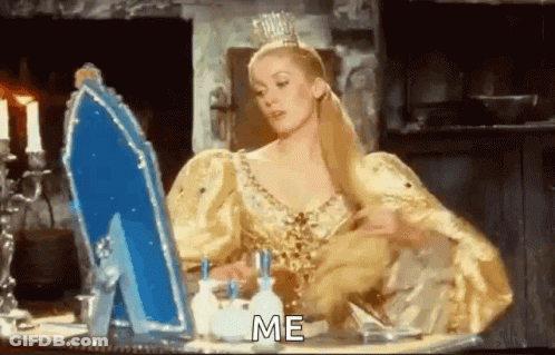 Woman In Yellow Dress Looking In Mirror Saying Me GIF