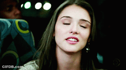 Woman In Yellow Dress Making Funny Face Next To Man GIF
