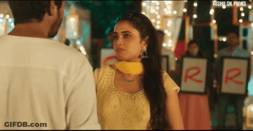 Woman In Yellow Dress Next To Man In White Shirt GIF