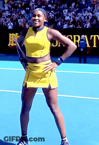 Woman In Yellow Dress On Tennis Court With Sr-At Sign GIF