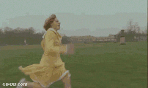 Woman In Yellow Dress Running In Field GIF