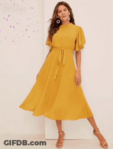 Woman In Yellow Dress With Ruffled Sleeves GIF
