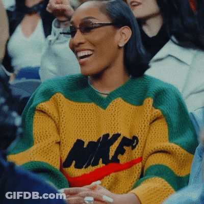Woman In Yellow Green Red Nike Sweater Smiling GIF