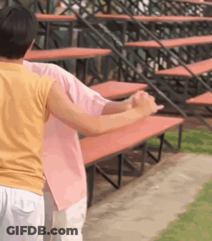 Woman In Yellow Holding Man In Pink GIF