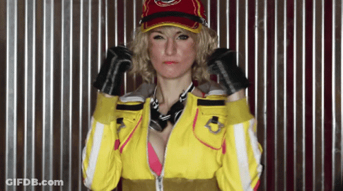Woman In Yellow Jacket And Red Hat With Bandana And Gloves GIF