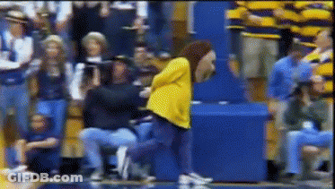 Woman In Yellow Jacket Dancing In Crowd GIF