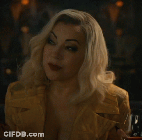 Woman In Yellow Jacket Holding Glass GIF