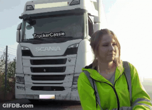 Woman In Yellow Jacket In Front Of White Scania Truck GIF