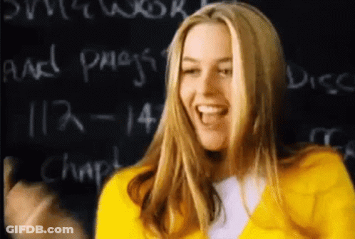 Woman In Yellow Jacket Laughing At Blackboard GIF