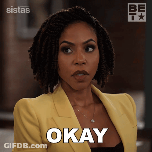 Woman In Yellow Jacket Saying Okay GIF