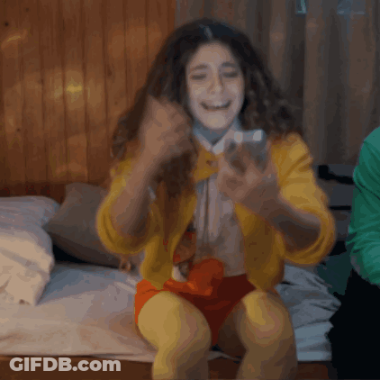 Woman In Yellow Jacket Taking Selfie GIF