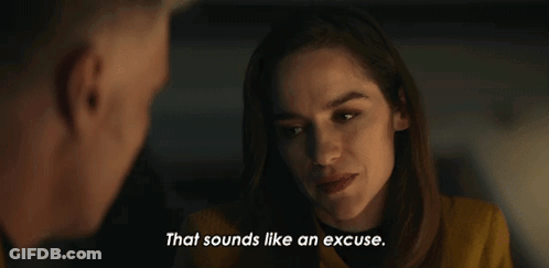 Woman In Yellow Jacket Talking To Man In Dark Room GIF
