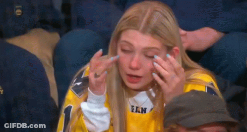 Woman In Yellow Jersey Crying In Crowd GIF