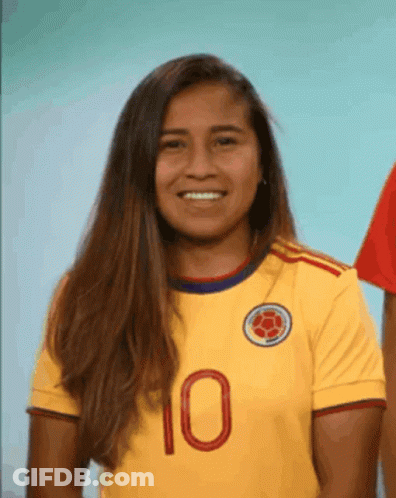 Woman In Yellow Jersey Number 10 Smiles GIF