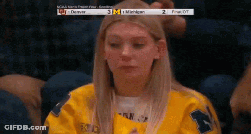Woman In Yellow Jersey Watching Game At Stadium GIF