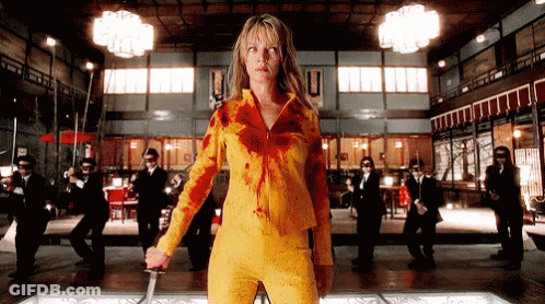 Woman In Yellow Outfit Holding Sword GIF