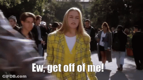 Woman In Yellow Plaid Jacket Saying Ugh In Crowd GIF