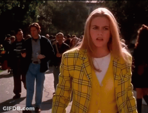 Woman In Yellow Plaid Jacket Talking To Crowd GIF