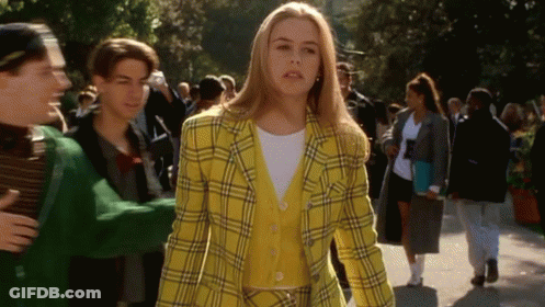 Woman In Yellow Plaid Jacket Walking GIF